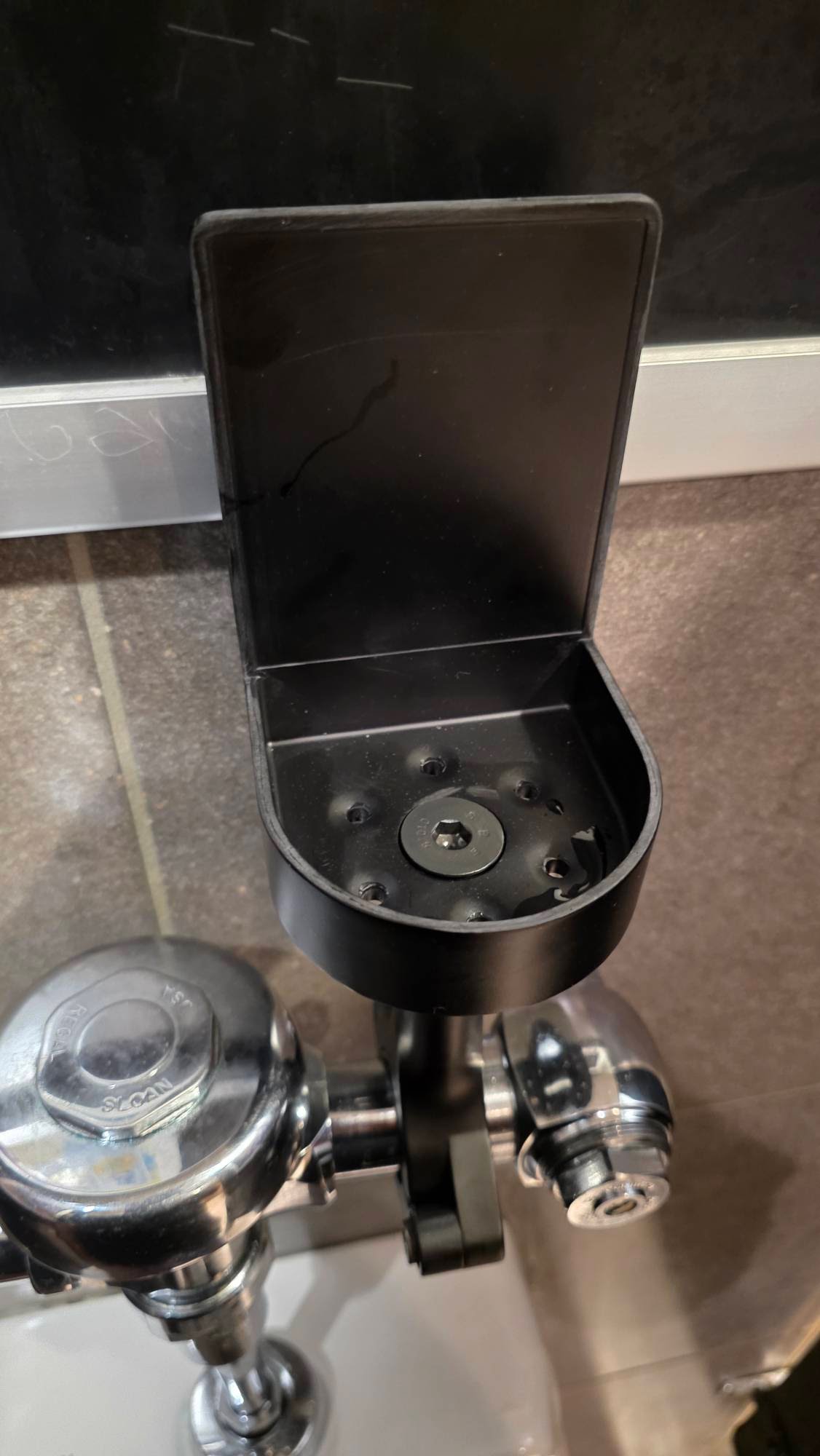Urinal flush valve before DrinkTight installation